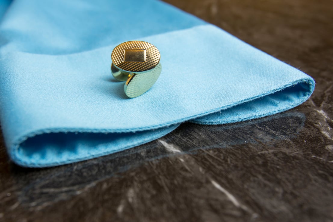 Gold cuff links on dress shirt